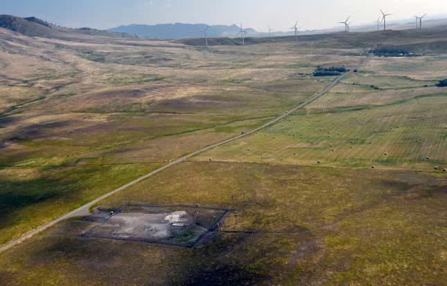 In this image provided by the U.S. Air Force, wind turbines spin near the Malmstrom Air Force Base missile launch site Alpha-03 in Geyser, Mont., in August 2023. As the nation&#39;s energy needs have increased, turbines have grown in size and number, and are being placed closer to the underground silos where Minuteman III intercontinental ballistic missiles are kept ready to fire. The Air Force is concerned that the turbines are making it dangerous for their helicopter crews to fly out to the sites, often flying low and fast, when responding to an alarm at one of the silos. The service is seeking a two nautical mile buffer zone around the sites. (John Turner/U.S. Air Force via AP)