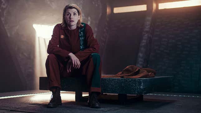 Jodie Whittaker's 13th Doctor wearing alien prison clothes and locked in an isolated cell.