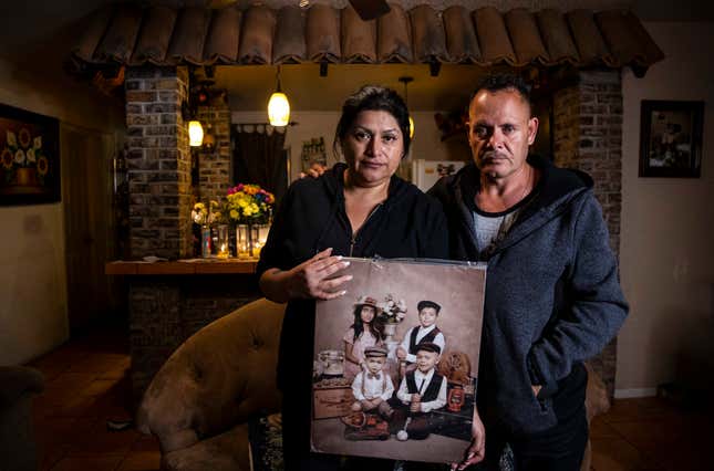 FILE - Erlinda Zacarias, left, and her husband, Jesus Mejia-Santana, pose for a photo, Jan. 31, 2022, while holding a portrait showing four of their six children who died on Jan. 29, 2022, in a mass-casualty traffic collision that killed multiple people in North Las Vegas. The children, counter clockwise from upper left, are Lluvia Zacarias, Bryan Zacarias, Adrian Zacarias and Fernando Mejia. The National Transportation Safety Board wants automakers to install systems on all new vehicles that warn drivers when they go over the speed limit, and it is asking safety regulators to figure out how states can electronically limit speeds on vehicles driven by repeat traffic offenders. NTSB&#39;s recommendations to combat excessive speeding came after a hearing Tuesday, Nov. 14, 2023, on the January 2022 crash in North Las Vegas. (Chase Stevens/Las Vegas Review-Journal via AP, File)