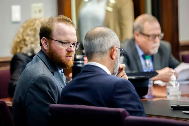 Travis McMichael, left, speaks with his attorney Jason B. Sheffield , center, during his sentencing, alone with his father Greg McMichael and neighbor, William “Roddie” Bryan in the Glynn County Courthouse, Friday, Jan. 7, 2022, in Brunswick, Ga. The three found guilty in the February 2020 slaying of 25-year-old Ahmad Arbery.