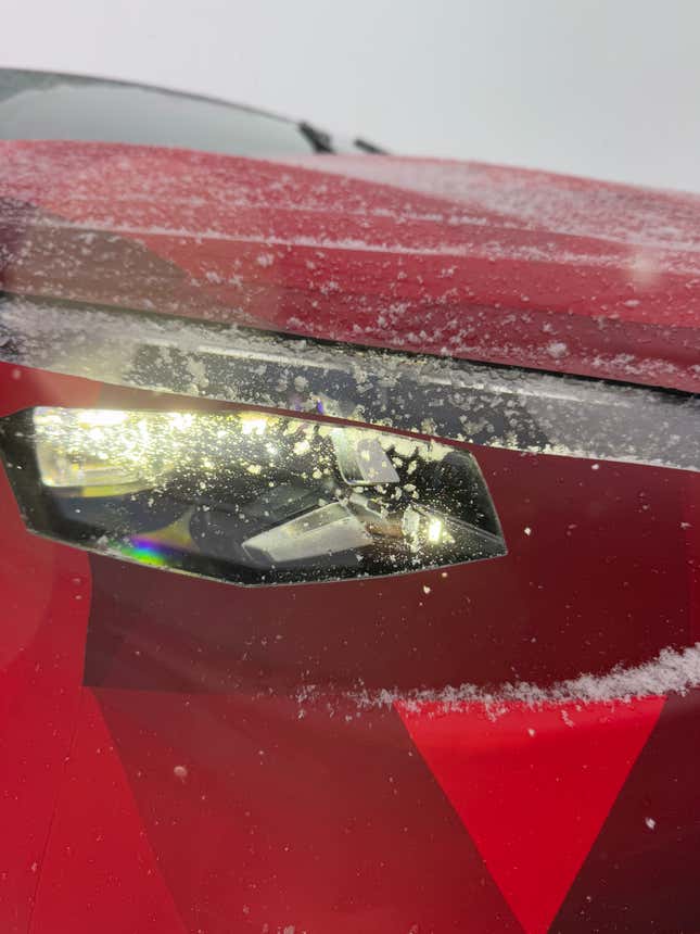 Headlight of a camouflaged Mercedes-Benz CLA EV prototype