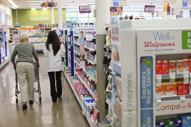 Pharmacist Jeanie Kim (R) helps a customer at a Walgreens pharmacy in Wheeling, Illinois. 