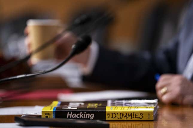 a copy of "hacking for dummies" sits on a desk