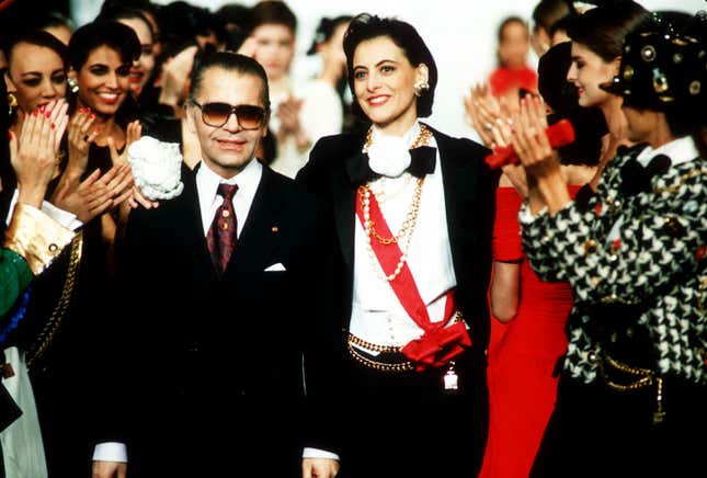 Chanel's top model Ines de la Fressange has her arm around West German designer Karl Lagerfeld as models applaud at the end of Chanel's fall and winter 1987 ready-to-wear collection in Paris, France, March 23, 1987.