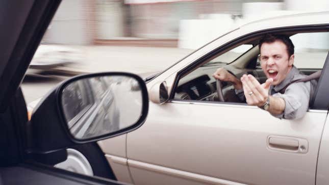 Man in car gesticulating angrily at another driver (blurred motion)