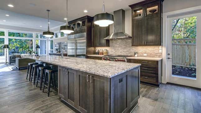 Kitchen with oversized kitchen island with seating and workspace and cabinets