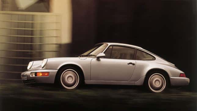 A profile photo of a silver Porsche 911 sports car. 