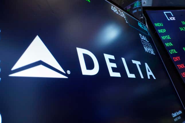 FILE - The logo for Delta Air Lines appears on a screen above a trading post, on the floor of the New York Stock Exchange, Thursday, July 13, 2023. Delta Air Lines earned $2 billion in the fourth quarter, posted record full-year revenue, and says it&#39;s buying more planes to boost its international flying. (AP Photo/Richard Drew, File)