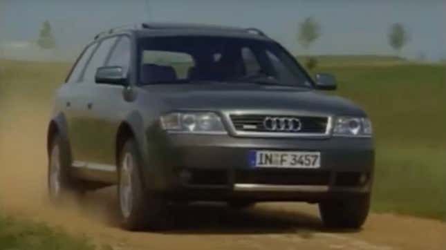 A gray Audi Allroad drives down a dirt road