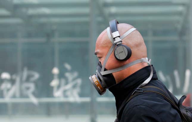 A man in Beijing wears one of the more involved face mask options.