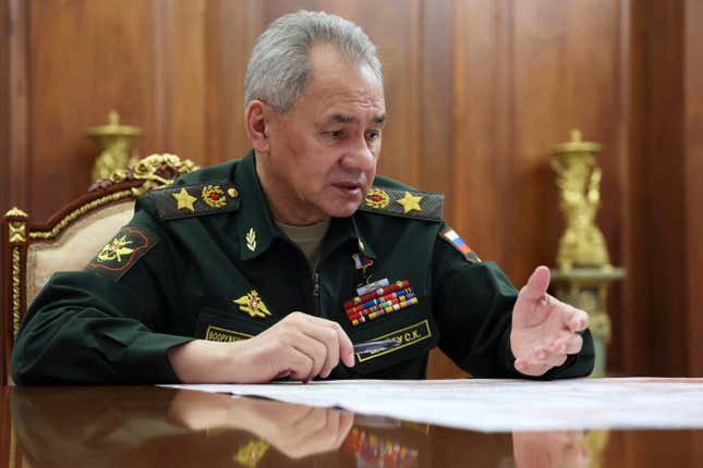 Russian Defense Minister Sergei Shoigu gestures while speaking to Russian President Vladimir Putin during their meeting at the Kremlin in Moscow, Russia, Tuesday, Feb. 20, 2024. (Alexander Kazakov, Sputnik, Kremlin Pool Photo via AP)