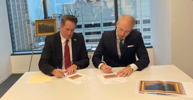 FBI Special Agent David White, left, and Bernd Ebert, a curator at the Alte Pinakothek in Munich, sign documents returning the 18th century painting titled &quot;Landscape of Italian Character&quot; by Vienna-born artist Johann Franz Nepomuk Lauterer, Thursday, Oct. 19, 2023 in Chicago. After going missing nearly 80 years ago, the &quot;Landscape of Italian Character&quot;, a baroque landscape painting was returned to a German museum representative in a brief ceremony at the German Consulate in Chicago, where the pastoral piece of an Italian countryside was on display. (AP Photo/Claire Savage)