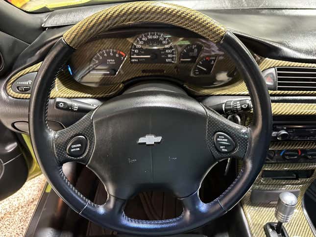 A shot of the steering wheel and gauges showing lots of carbon fiber ad-ons