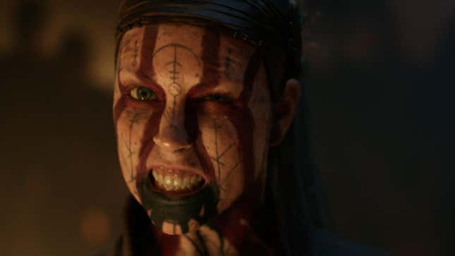 Senua snarls at the camera with tattoos and face paint.