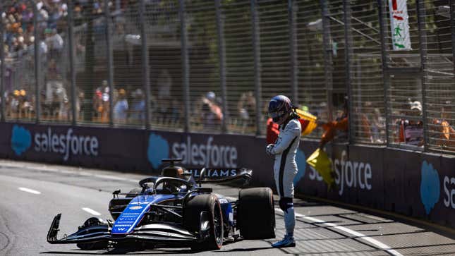 A photo of Alex Albon looking at his crashed Williams F1 car. 