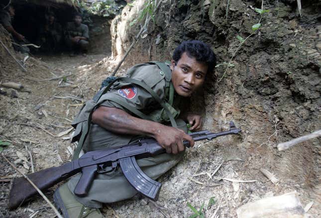 A Cambodian soldier crouches in a trench during fighting near the disputed Preah Vihear temple on Oct. 15, 2008.