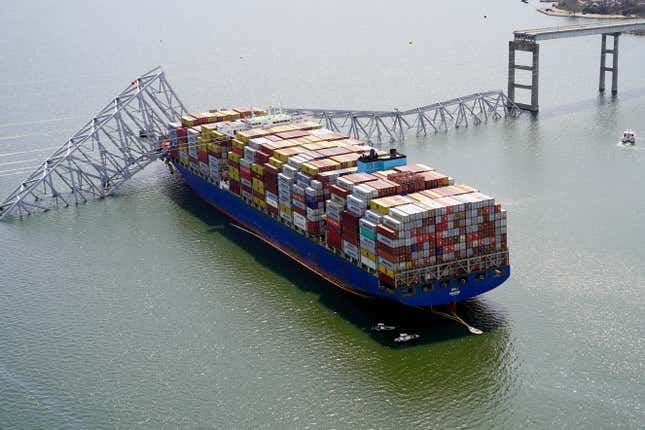 In this aerial image released by the Maryland National Guard, the cargo ship Dali is stuck under part of the structure of the Francis Scott Key Bridge after the ship hit the bridge, Tuesday, March 26, 2024, in Baltimore. (Maryland National Guard via AP)