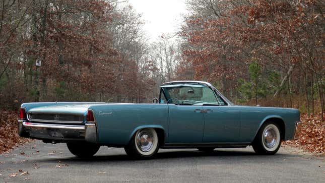 A photo of a pale blue Lincoln Continental car. 