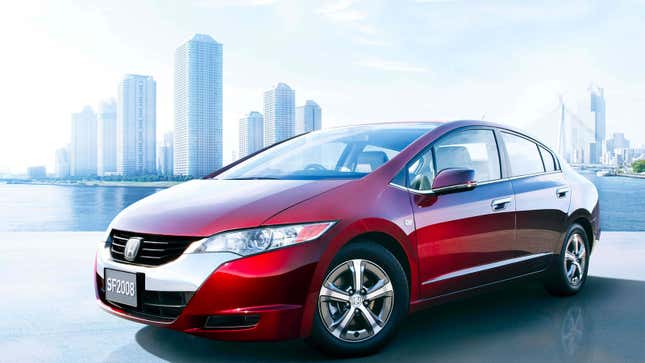 A photo of a red Honda Clarity sedan with a chrome bumper. 