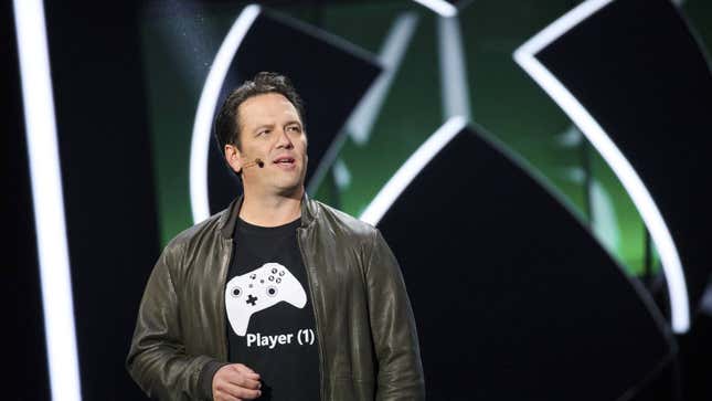 Phil Spencer speaks in front of an Xbox logo.