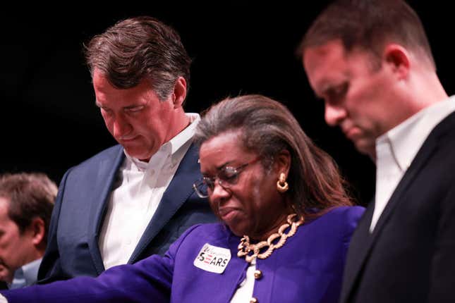 Virginia Republican gubernatorial candidate Glenn Youngkin, Republican candidate for lieutenant governor Winsome Sears and Republican attorney general candidate Jason Miyares pray during a worship service at the Highlands Fellowship Church on October 31, 2021 in Abingdon, Virginia.