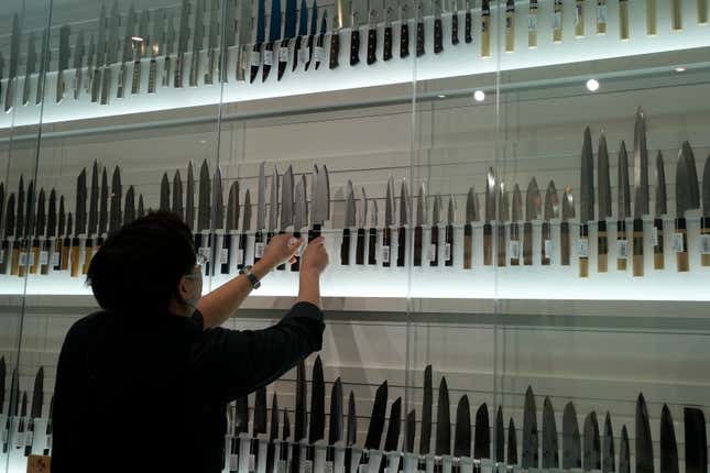 A staff arranges variety of kitchen knives at a kitchen knife store at &quot;Toyosu Senkyaku Banrai,&quot; an Edo Period-themed hot spring complex on media preview eventat Toyosu Market Monday, Jan. 29, 2024, in Tokyo. Japan&#39;s biggest fish market on Thursday opened a long-awaited outer section with Japanese-style seafood restaurants and a spa for relaxation, as the wholesale venue that has struggled since relocating from the beloved Tsukiji market seeks to lure more visitors. (AP Photo/Eugene Hoshiko)