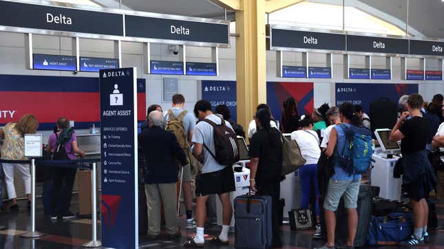 Delta Air Lines passengers waiting at a check-in counter