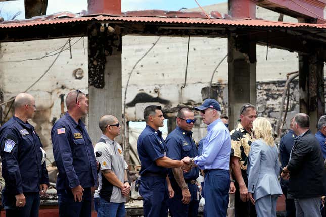 FILE - President Joe Biden and first lady Jill Biden greet first responders as they visit areas devastated by the Maui wildfires, Aug. 21, 2023, in Lahaina, Hawaii. The White House is asking lawmakers for more than $23 billion in emergency funding to help the government respond to the natural disasters that have ripped through the U.S. this year. (AP Photo/Evan Vucci, File)