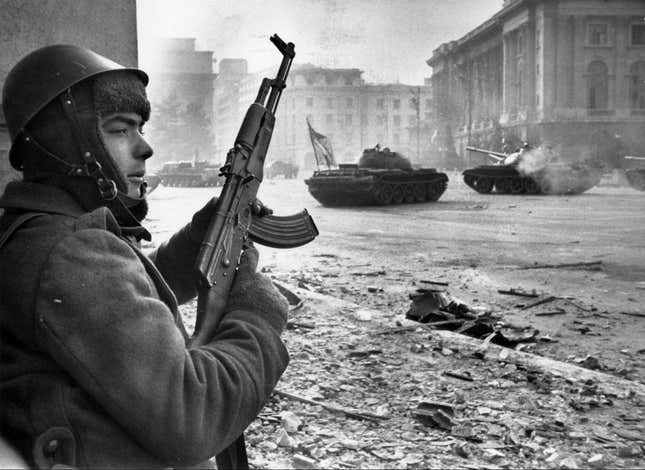 Romanian soldier taking cover during a battle between the army and pro-Ceausescu supporters in Bucharest on Dec. 24, 1989.