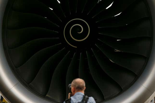 FILE - A visitor takes a photo of the Rolls-Royce jet engine of the Airbus A350-1000 parked at the static display area during the Singapore Airshow on Feb. 7, 2018, in Singapore. Jet engine maker Rolls-Royce said Tuesday Oct. 17, 2023 it&#39;s cutting up to 2,500 jobs globally as part of a corporate overhaul that its new CEO is carrying out. (AP Photo/Yong Teck Lim, File)