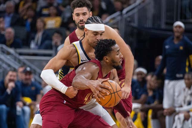 Oct 20, 2023; Indianapolis, Indiana, USA; Cleveland Cavaliers guard Donovan Mitchell (45) dribbles the ball while Indiana Pacers guard Andrew Nembhard (2) defends  in the second half at Gainbridge Fieldhouse.