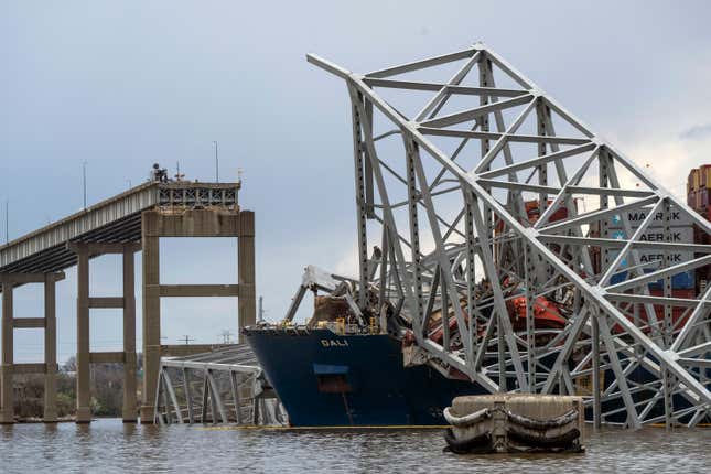 The site of the collapsed Francis Scott Key Bridge and the container ship that toppled it, Dali, are seen from a debris retrieval vessel, the Reynolds, April 4, 2024. (Kaitlin Newman/The Baltimore Banner via AP)