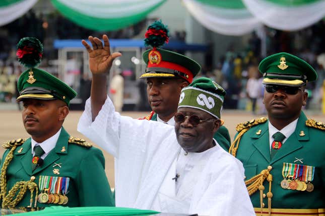 FILE - Nigeria&#39;s new President Bola Ahmed Tinubu, center, inspects honour guards after taking an oath of office at a ceremony in Abuja, Nigeria, on May 29, 2023. Nigeria&#39;s president has signed on Wednesday Nov. 8, 2023 a controversial bill that earmarks $6.1 million for a presidential yacht and millions more for sport utility vehicles for his wife and other top government officials. (AP Photo/Olamikan Gbemiga, File)