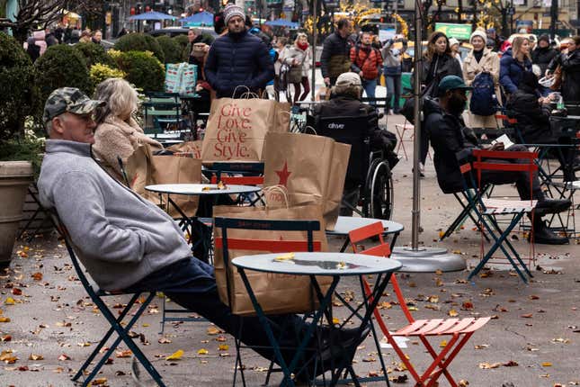 Shoppers rest with their purchases outside Macy&#39;s in Herald Square, on Monday, Dec. 11, 2023, in New York. Confidence is growing among Federal Reserve officials and many economists that high interest rates and healed supply chains will soon defeat inflation. (AP Photo/Yuki Iwamura)