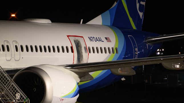 A plastic sheet covers an area of the fuselage of the Alaska Airlines N704AL Boeing 737 MAX 9 aircraft outside a hangar at Portland International Airport on January 8, 2024 in Portland, Oregon. 