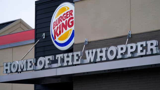 FILE - A &quot;Home of the Whopper&quot; sign welcomes customers outside the Burger King fast food restaurant, on Feb. 1, 2021, in Epping, N.H. The parent company of Burger King is buying out its biggest franchisee in the U.S. for about $1 billion. Restaurant Brands International Inc. will acquire all of the issued and outstanding shares of Carrols Restaurant Group Inc. that it doesn&#39;t already hold for $9.55 per share. (AP Photo/Charles Krupa)