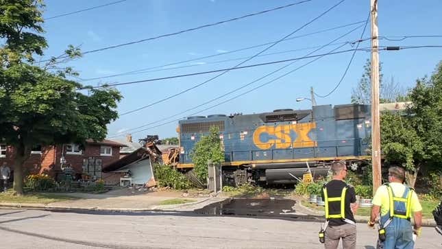 A CSX locomotive sitting in the debris of its derailment