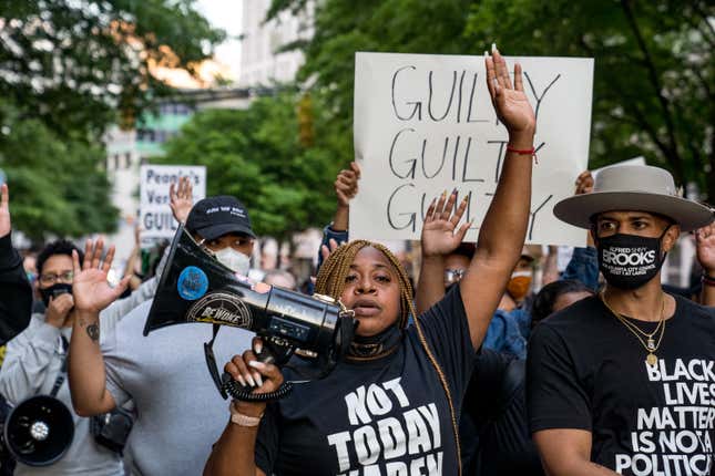 Porsche Queen Miller (center) and others march through the streets after the verdict was announced for Derek Chauvin on April 20, 2021 in Atlanta.