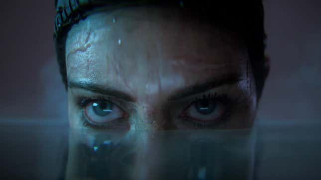 Senua looks past the camera with her face half-submerged in water.