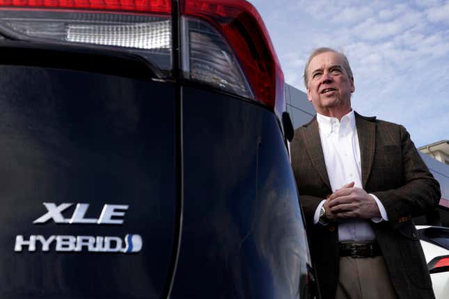 Scott Adams, owner of Adams Toyota, stands with a hybrid Toyota RAV4 at his dealership Tuesday, Dec. 12, 2023, in Lee&#39;s Summit, Mo. A typical hybrid costs somewhat more than its gasoline counterpart. A Toyota RAV4 hybrid with all-wheel-drive, for example, starts at $32,825, $1,600 more than a comparable gas version. (AP Photo/Charlie Riedel)