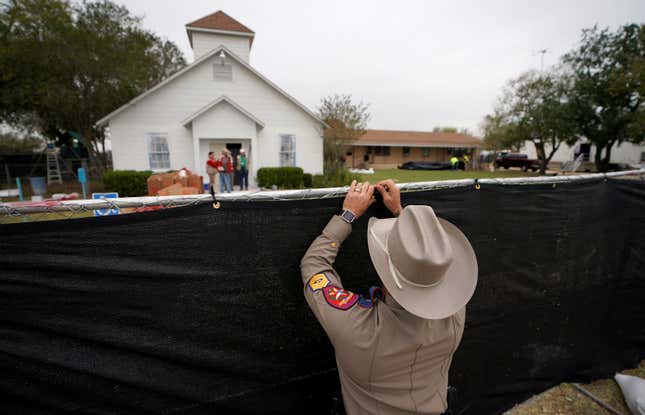 A Texas state trooper helps erect a fence around the site of the shooting at the First Baptist Church of Sutherland Springs, Texas, on Nov. 9, 2017