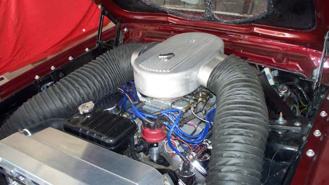 A photo of a Ford engine in a vintage car. 