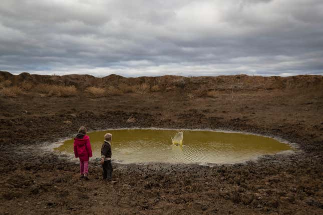 Children at a depleted dam.