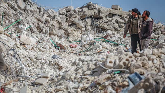 An image of a couple of people conducting search-and-rescue efforts after two earthquakes decimated Syria and Turkey this week.