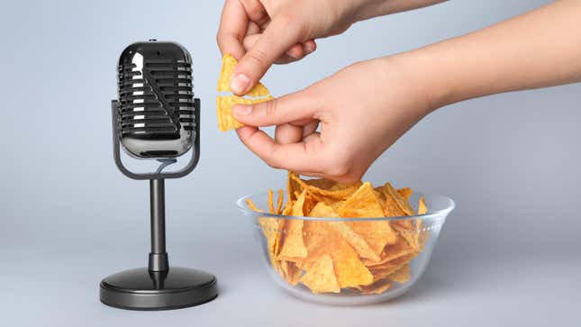 hands holding chips next to microphone