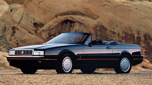 A photo of a black Cadillac Allante with its roof down. 