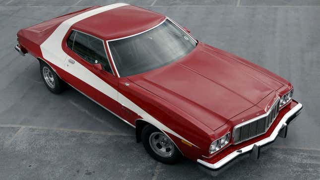 A photo of a red and white Ford Gran Torino. 