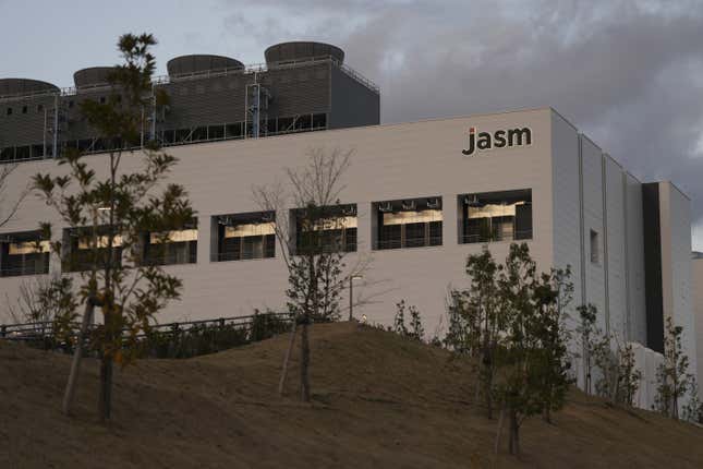 JASM signage atop Taiwan Semiconductor Manufacturing Co.'s (TSMC) new factory in Kikuyo, Kumamoto Prefecture, Japan, a white building with a row of windows