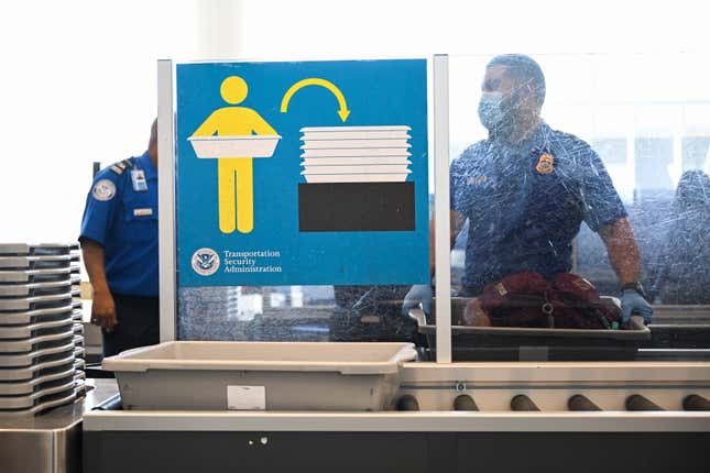 A Transportation Security Administration (TSA) agent screens carry-on baggage at Los Angeles International Airport (LAX) in Los Angeles, California, on August 10, 2022. 