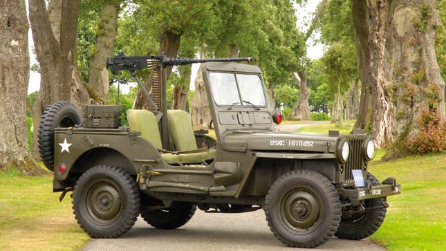 A photo of an original military Jeep with a gun on its roof. 